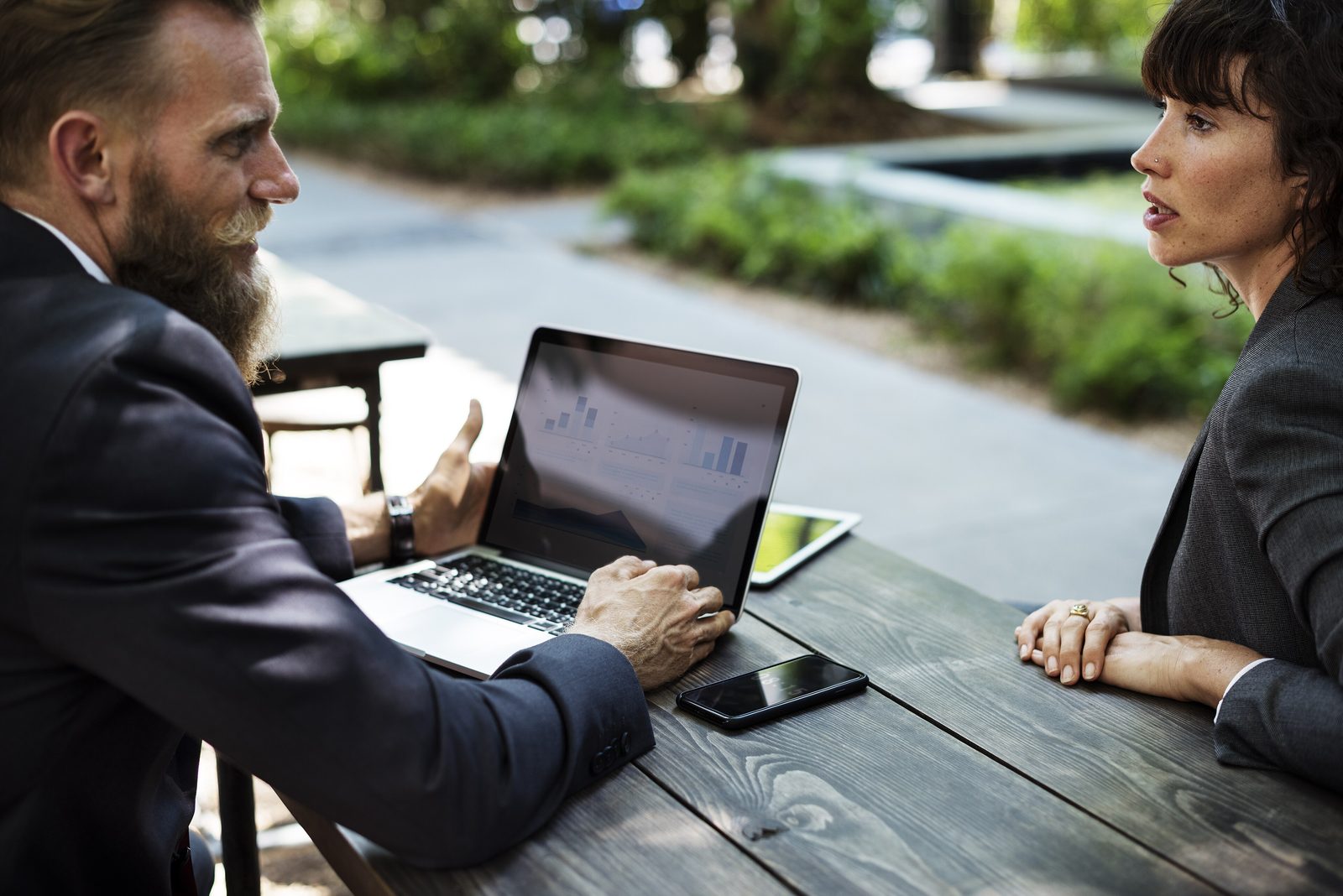 Consultant and client reviewing a plan together on a laptop